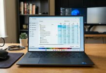 Discord Using Too Much CPU on Windows 11? Here’s How to Fix It Laptop on a desk displaying the Windows Task Manager with CPU and memory usage statistics for active processes